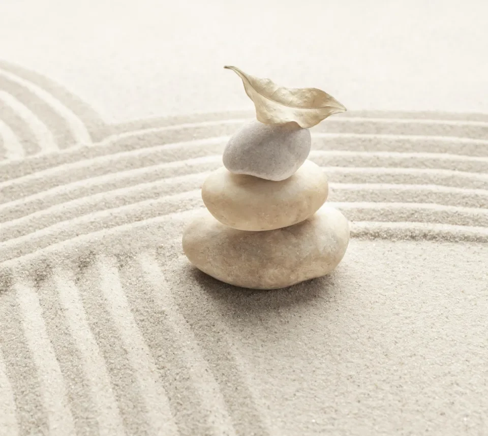 stacked zen marble stones sand background