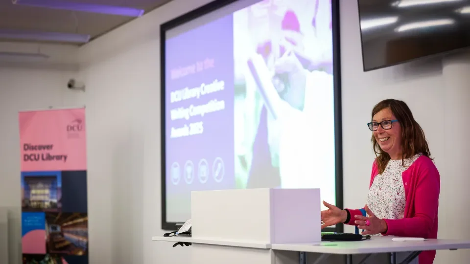a woman speaks from a lectern