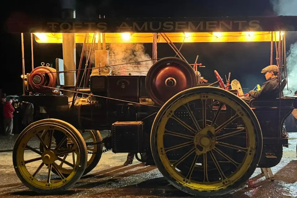 Vintage Showman's Steam Tractor lit up by warm yellow lighting