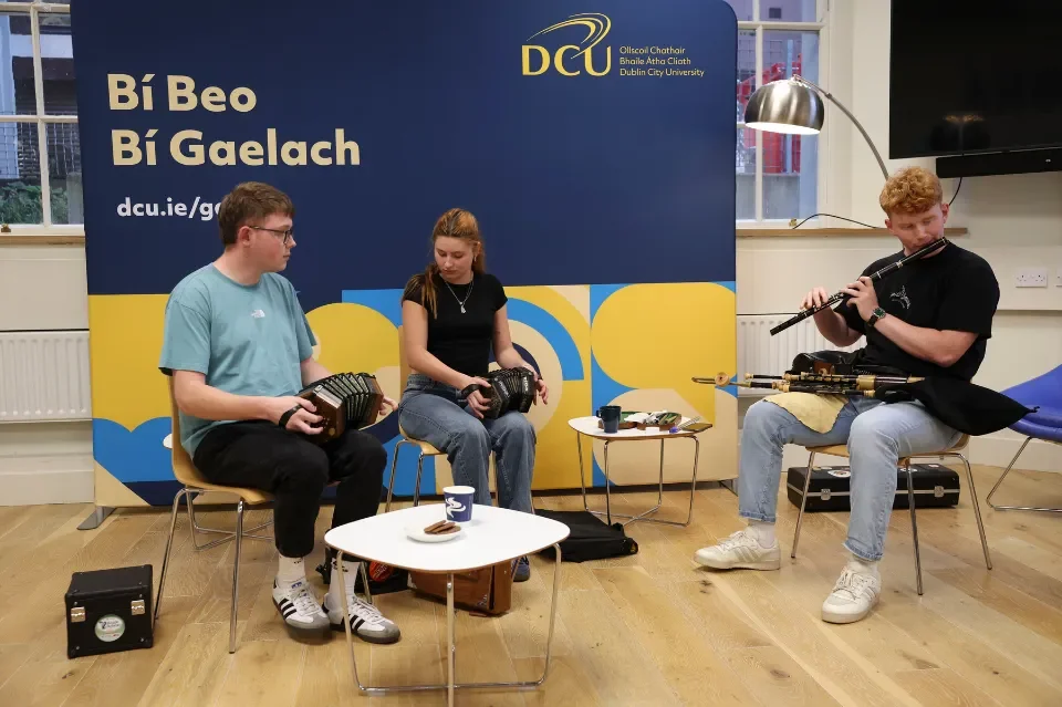 Three musicians playing traditional Irish instruments