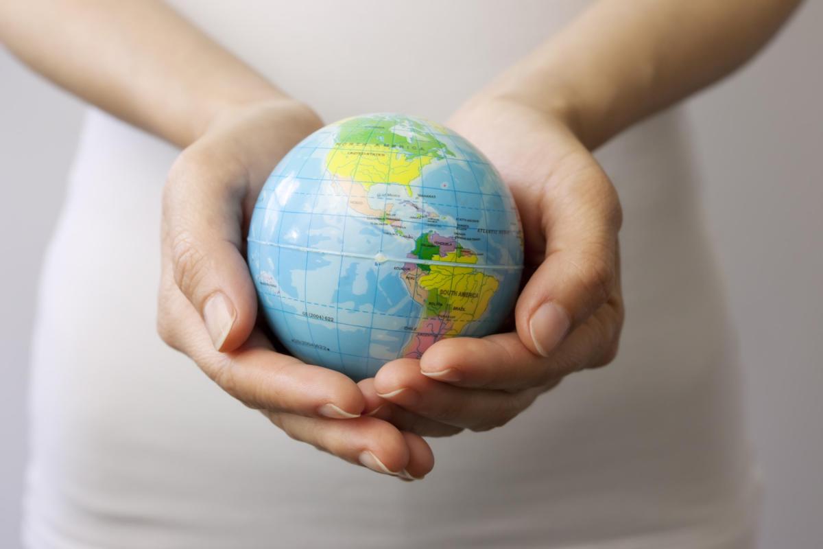 DCU postgraduate programme on Climate Change: Policy, Media and Society depicted by a globe held by two hands