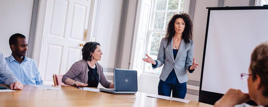 Women standing presenting to room