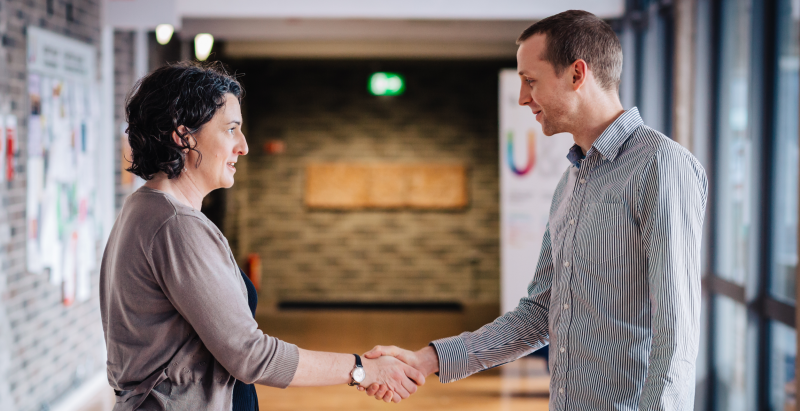 Man and woman shaking hands