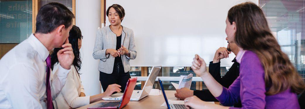 Woman standing at whiteboard