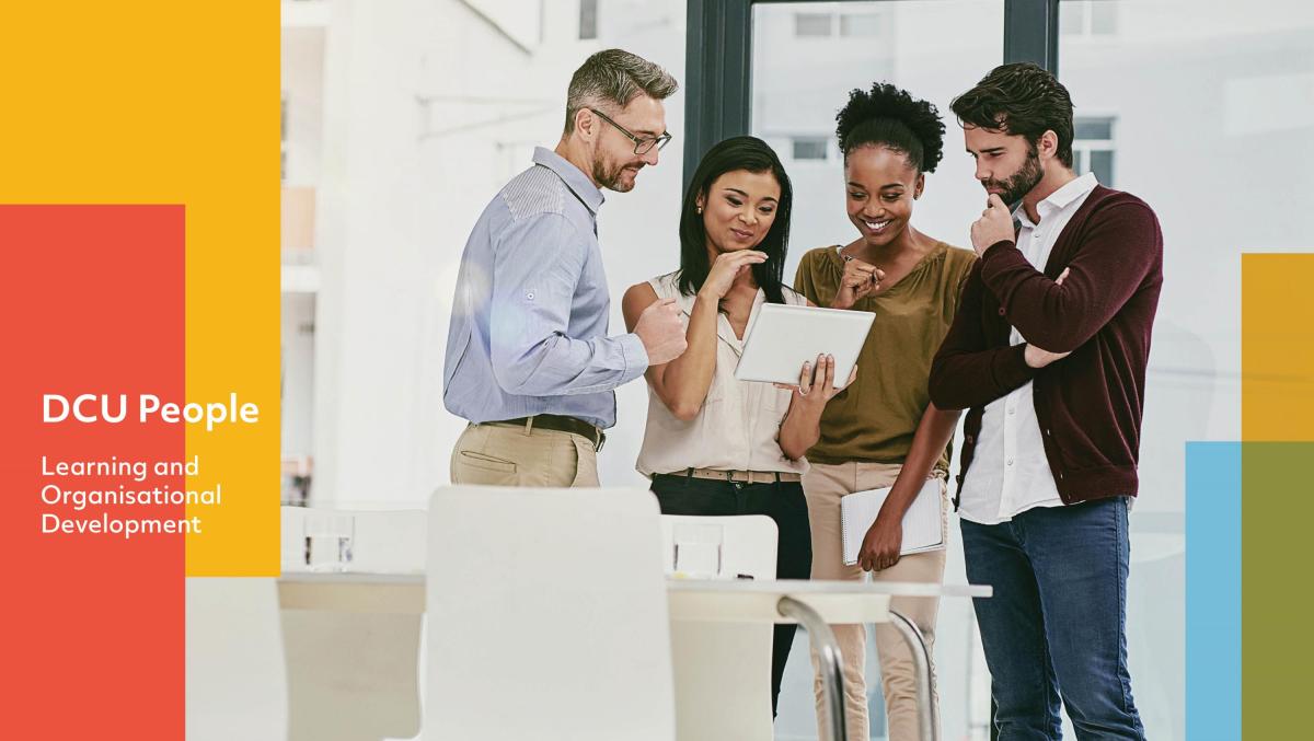 Group of people gathered around a tablet