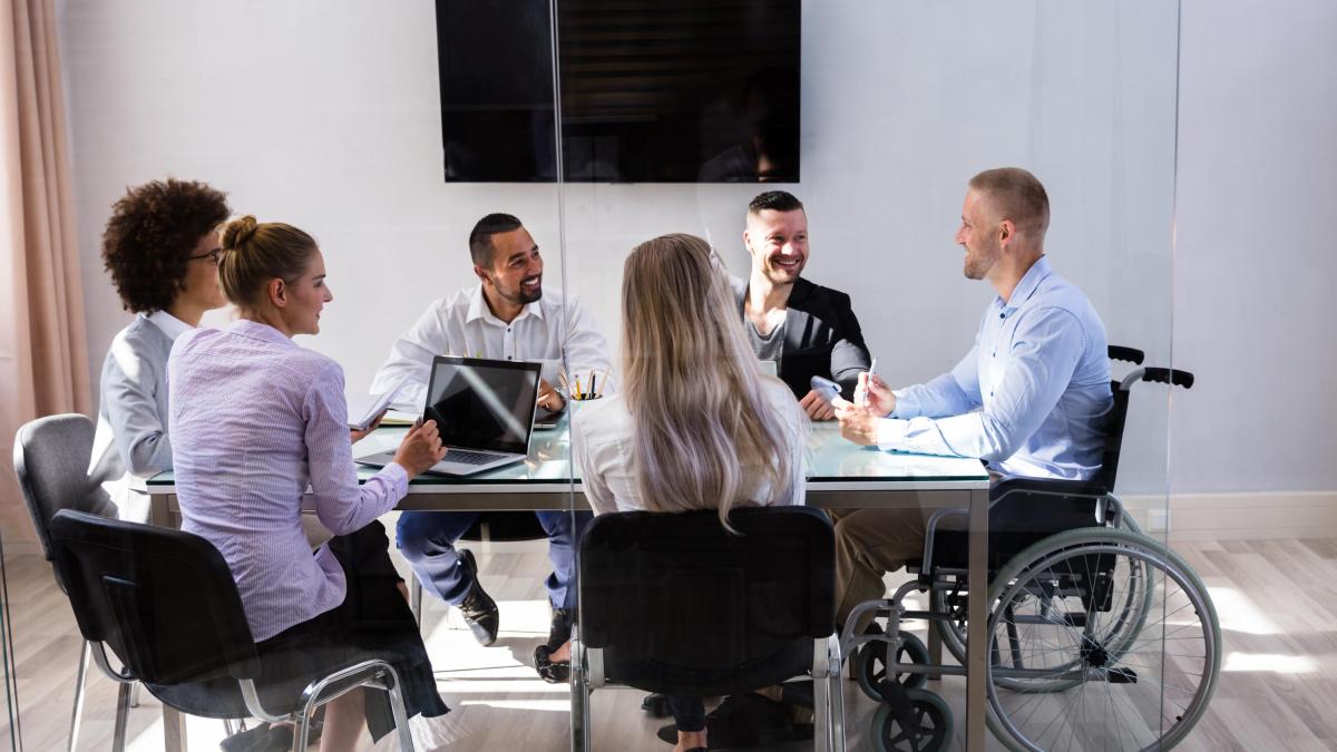 A diverse group of colleagues sitting around a table having a discussion.