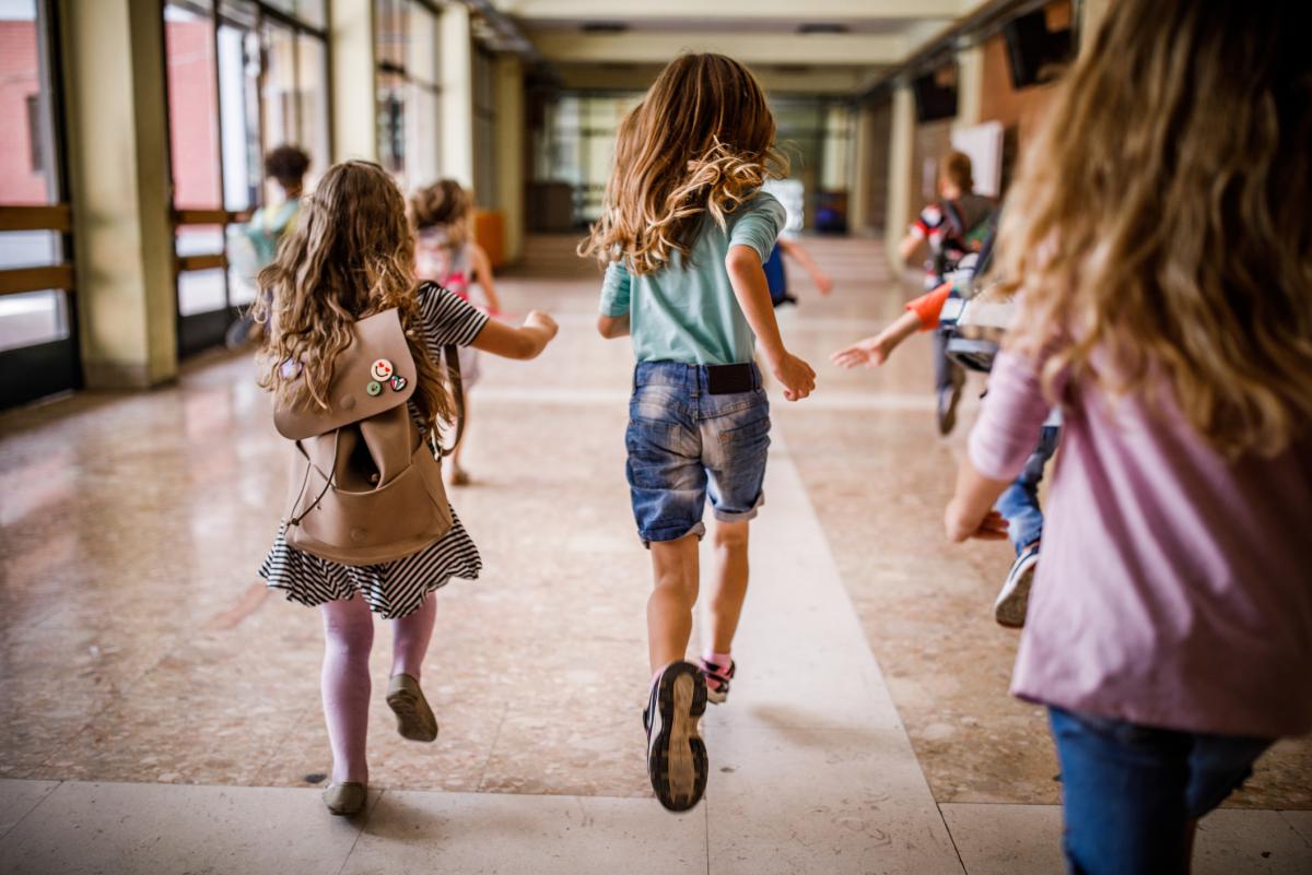 School Children Running Down a Hall