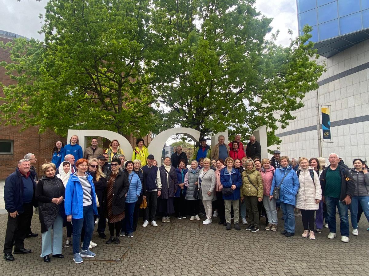 Ukrainian and Irish people in front of the DCU sign 