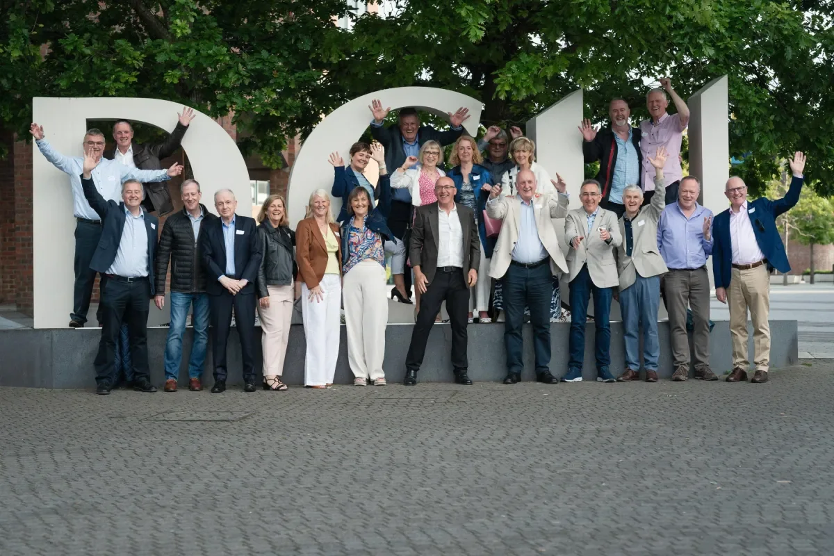 1984 reunion group outside DCU letters