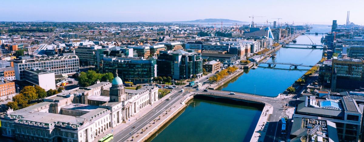 Shows aerial view of dublin city centre with the Liffey in foreground