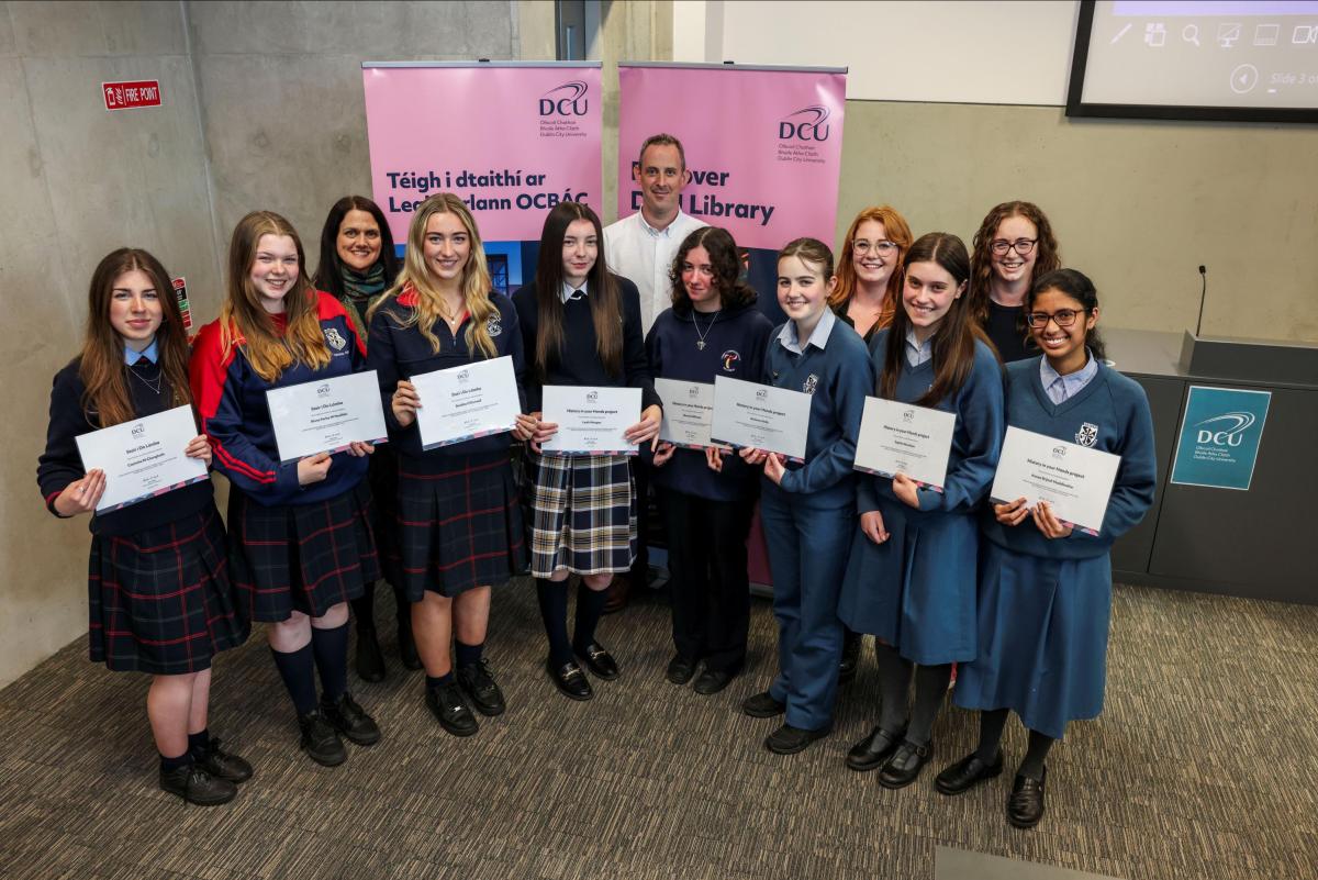 The History in Your Hands project team (Eilís O'Neill, Killian Downing, Hayley Brabazon and Celine Campbell) with the 2024 project finalists from Scoil Chaitríona, Trinity Comprehensive and Dominican College