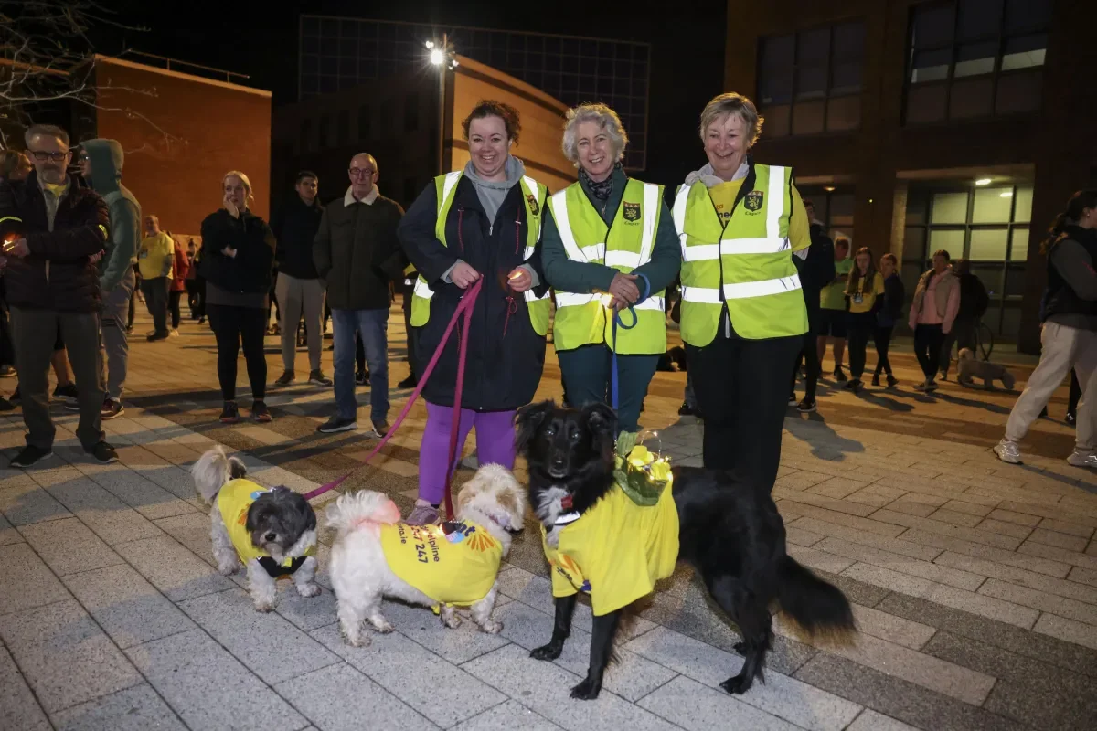 An image of three women and three dogs at the Darkness Into Light walk