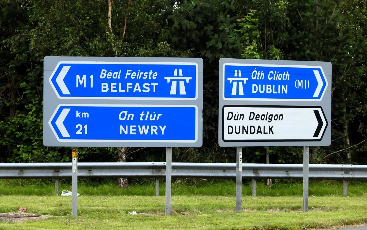 an image of four road signs depicting Dublin and Dundalk on one side and Newry and Belfast on the other