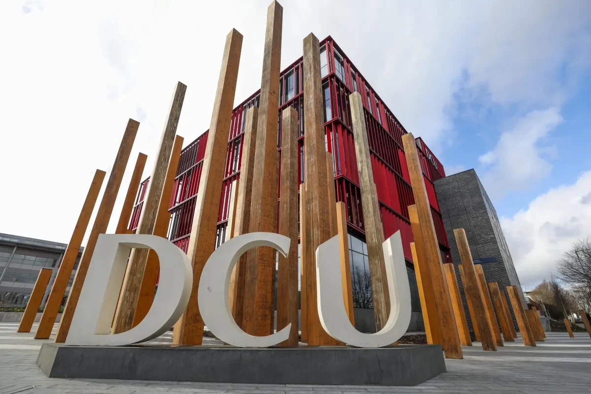 Shows DCU letters with Polaris building in the background
