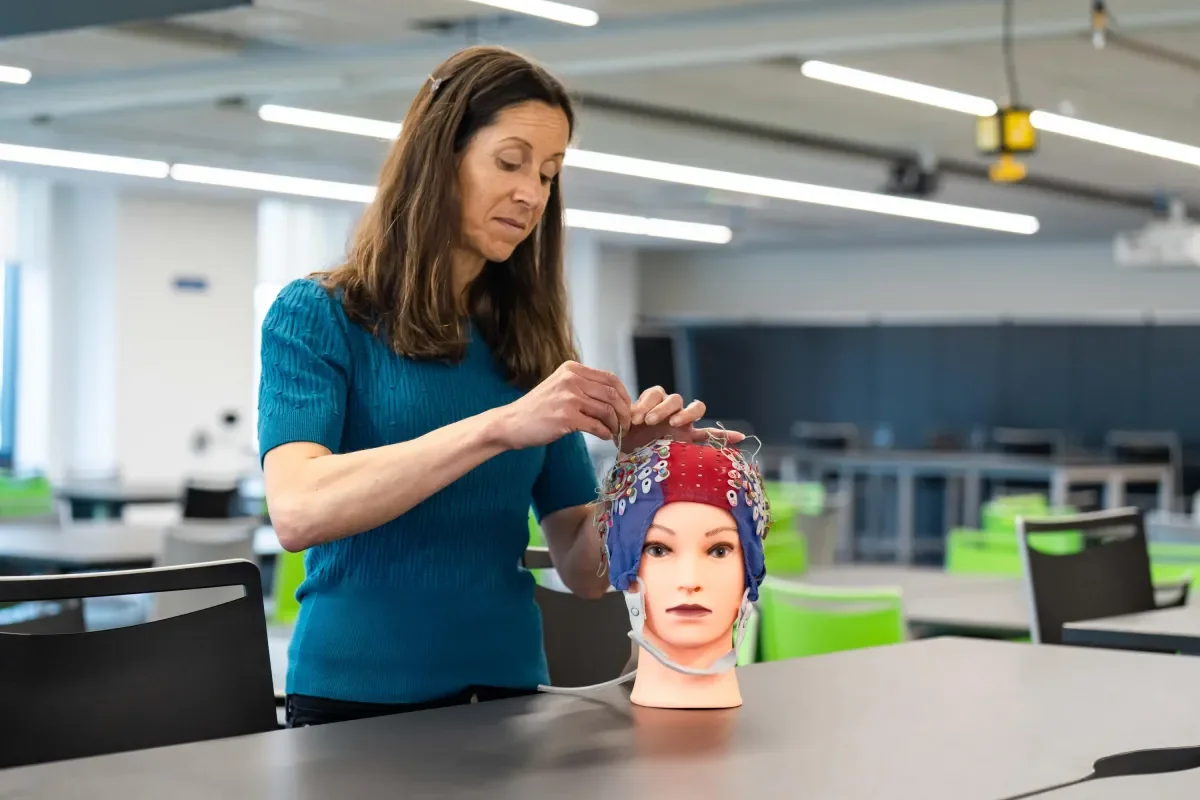 Shows Dr Shirley Coyle fixing sensors to dummies head