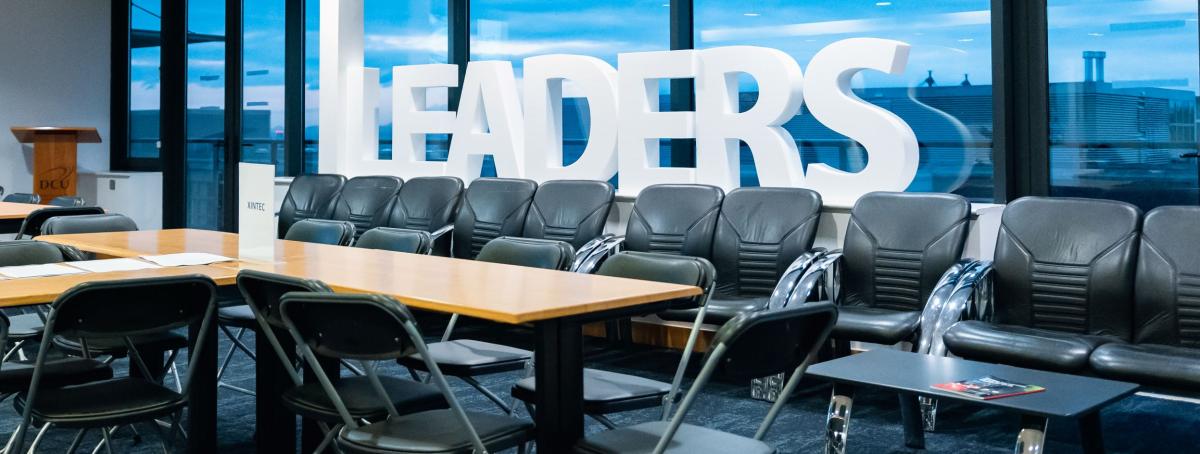 Boardroom view with letters 'LEADER' spelt out by window