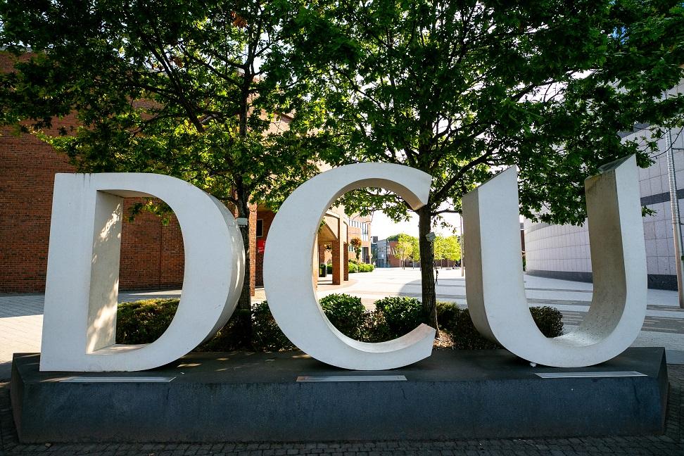 A photograph of the DCU logo arch on campus.