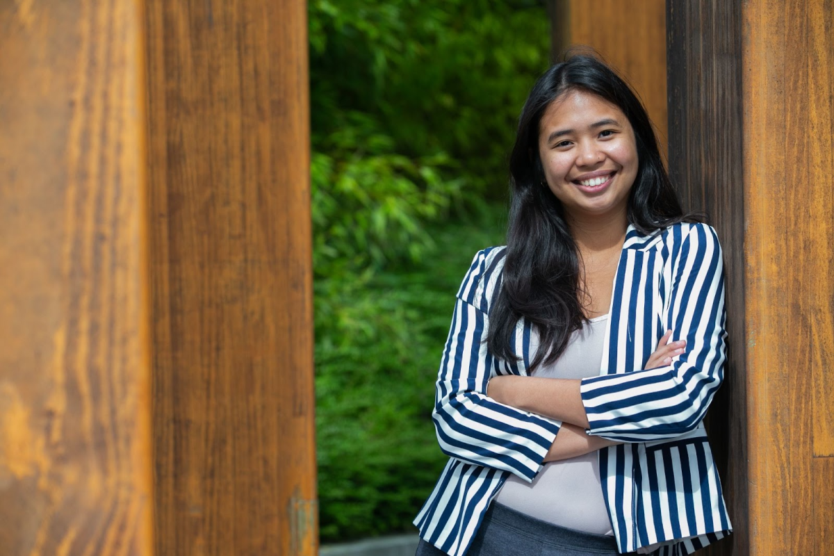 A smiling student standing on the DCU Campus