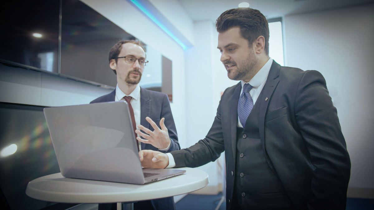 Two young professionals working together at a laptop.