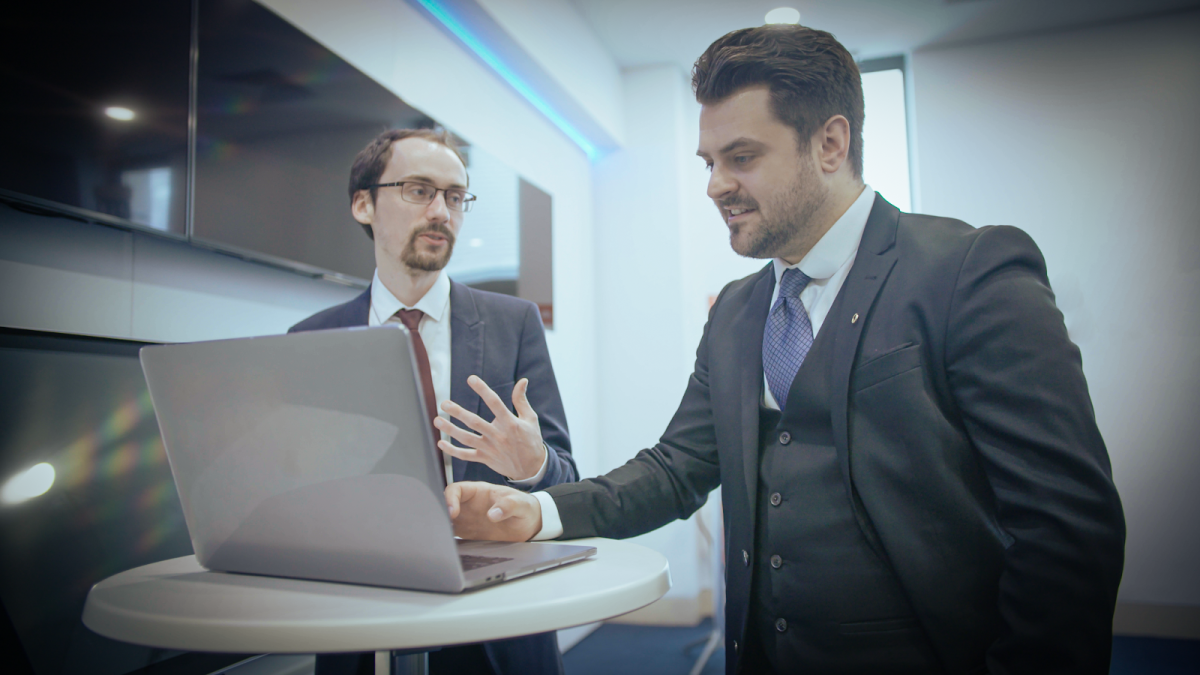 Two young professionals working together at a laptop. 