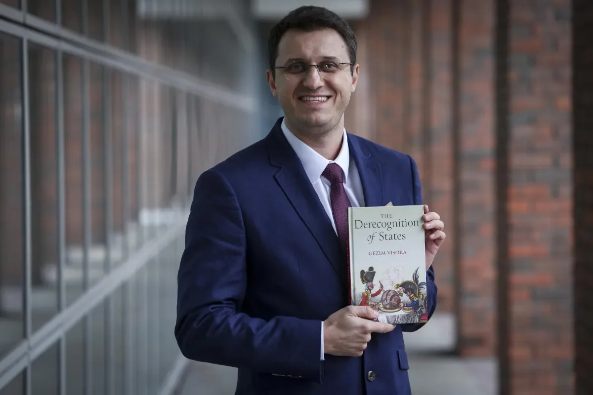 Shows Dr Gezim Visoka promoting his new book on DCU Glasnevin campus