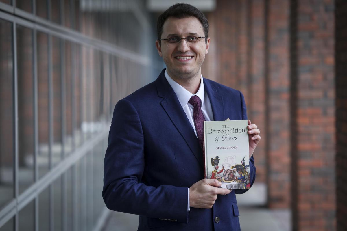 Shows Dr Gezim Visoka promoting his new book on DCU Glasnevin campus