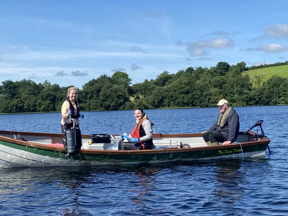 Three researchers on a boat