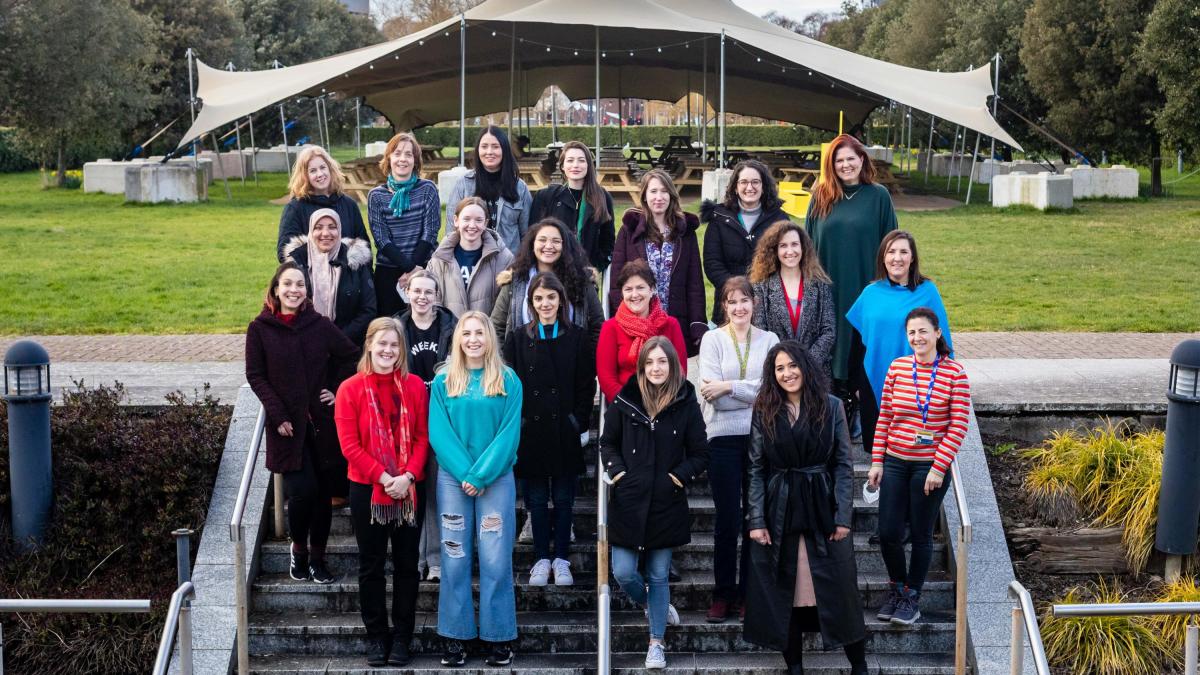 Image of women from the school on the steps of the library.