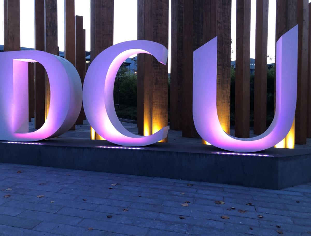 A DCU sign lit by purple lights. 70 buildings and landmarks across Ireland turned purple for Intersex Solidarity Day on 8 November 2020.