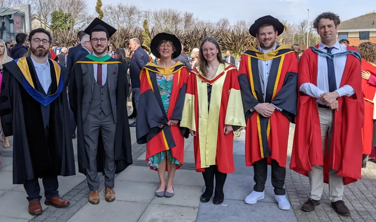 Michael Gaffney, Dr. Caitríona Ní Shé, and Dr. Aidan Fitzsimons at their graduation in March 2022 with their supervisors