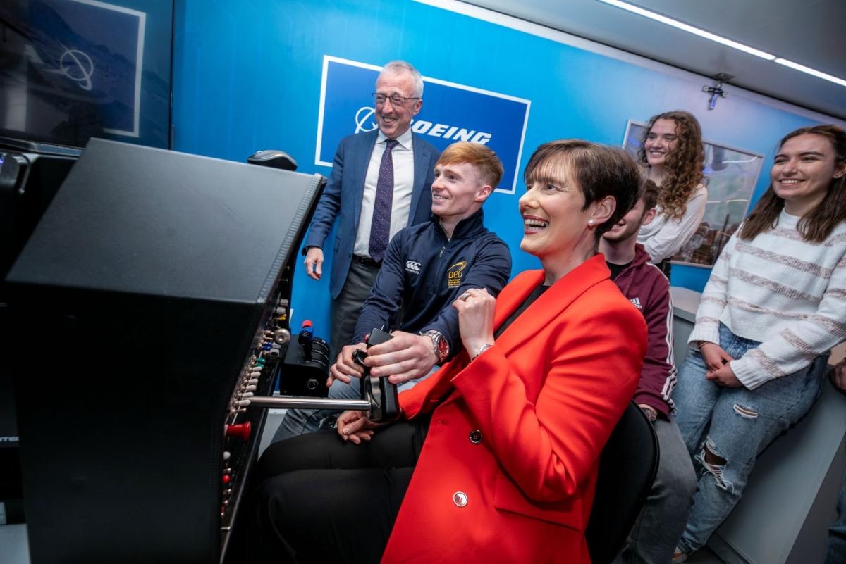 Minister Norma Foley with students and Sir Martin Donnelly, president of Boeing Europe and managing director of Boeing in the UK and Ireland.