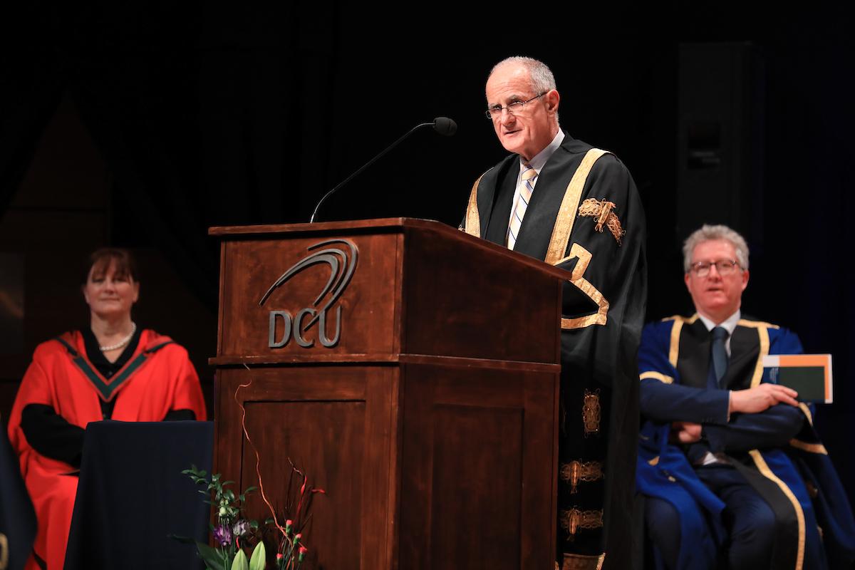 a man speaking at a podium