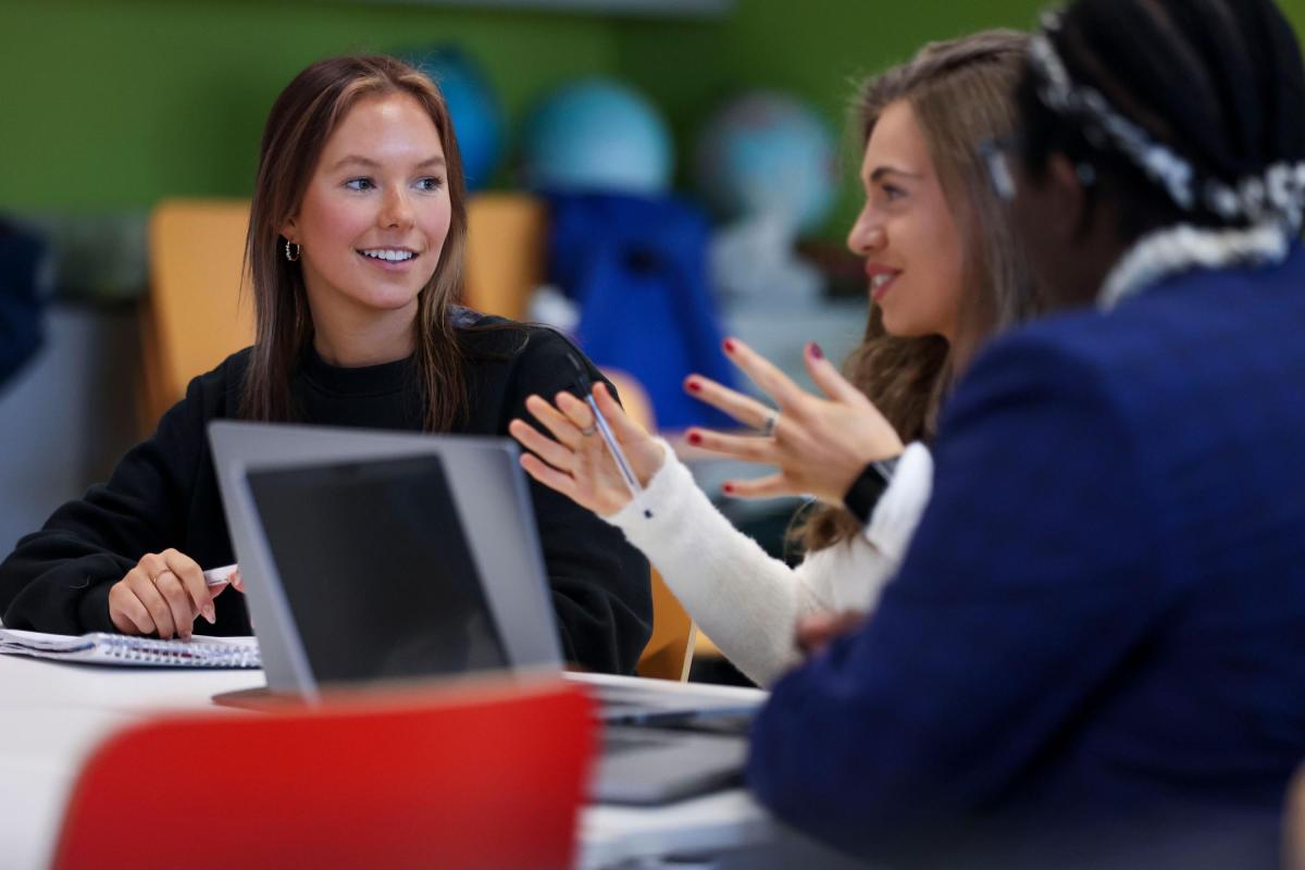 Students talking at a study desk