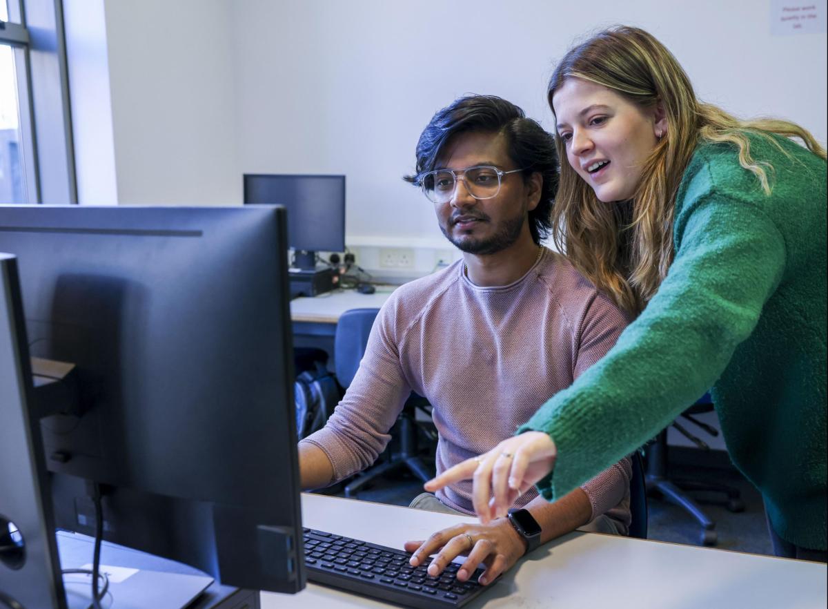 Students work on computer together