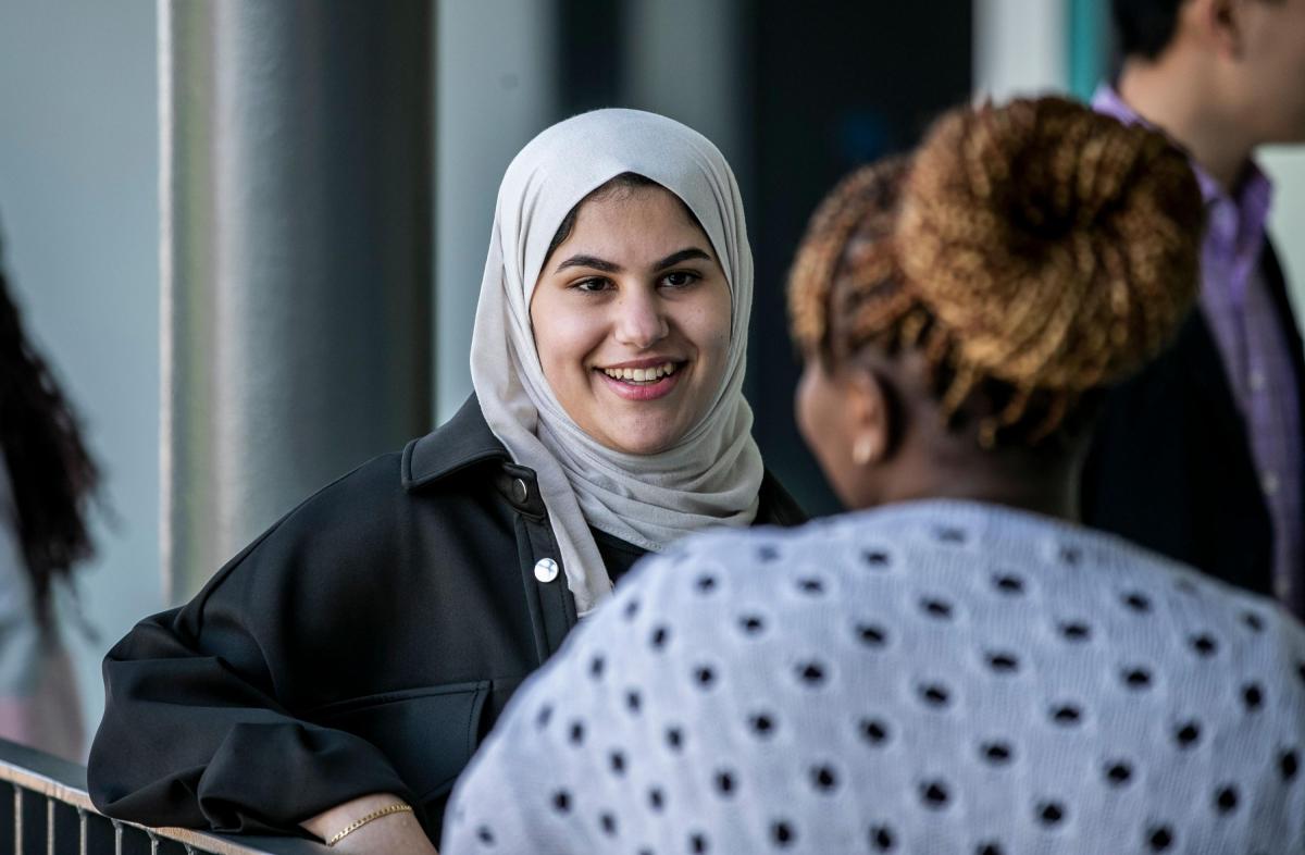 Student talks to another student