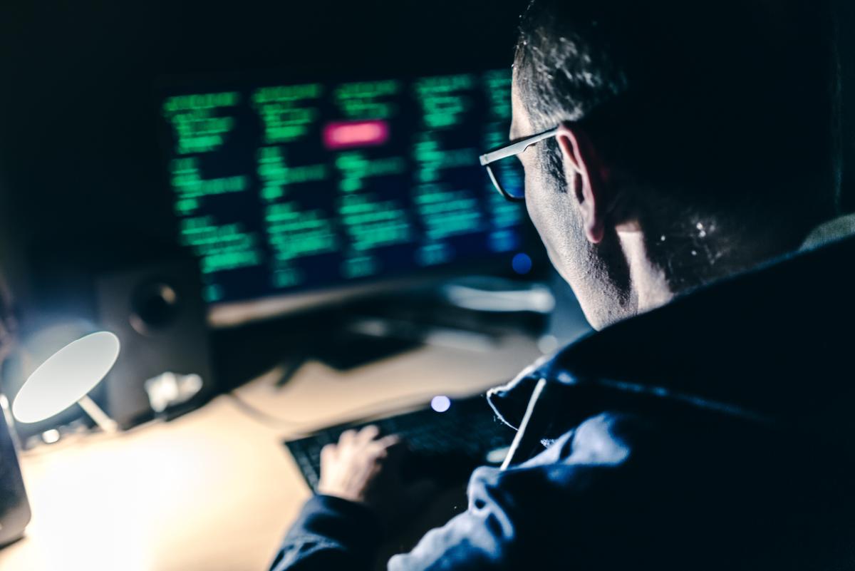 This image shows a man working on a computer