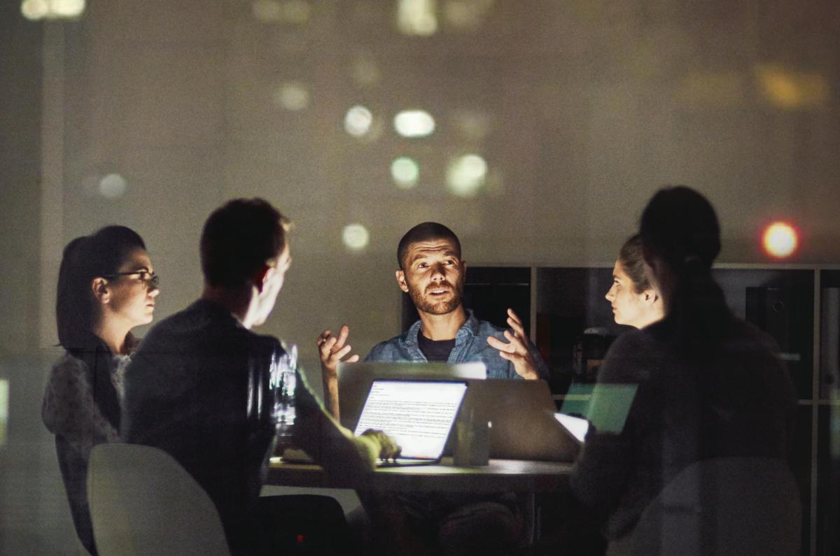 This image shows people working on laptops together