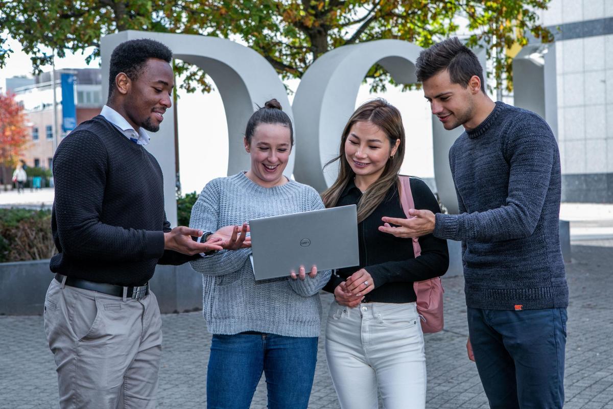 Students work on laptop together