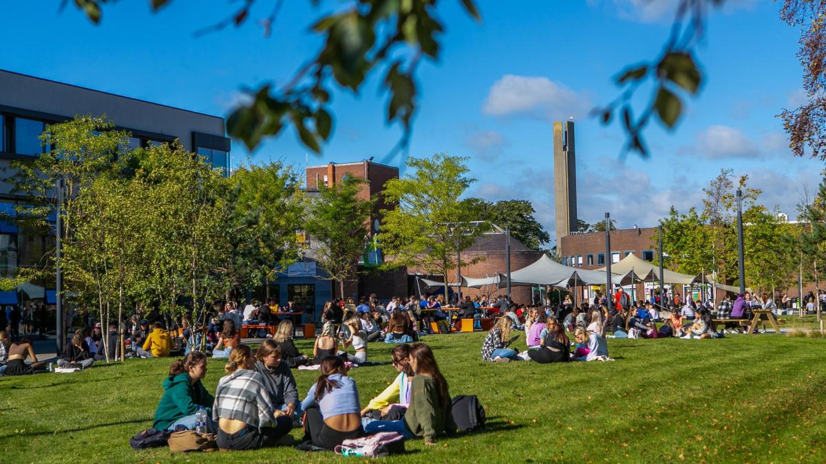 Students sit on the grass on DCU's Glasnevin Campus