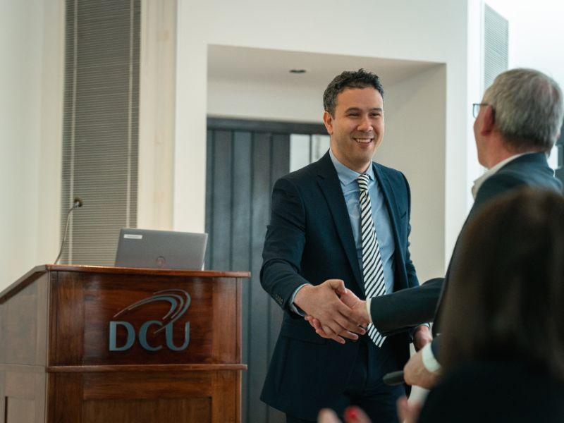 Shows doctor danny marks shaking hands with professor John Doyle