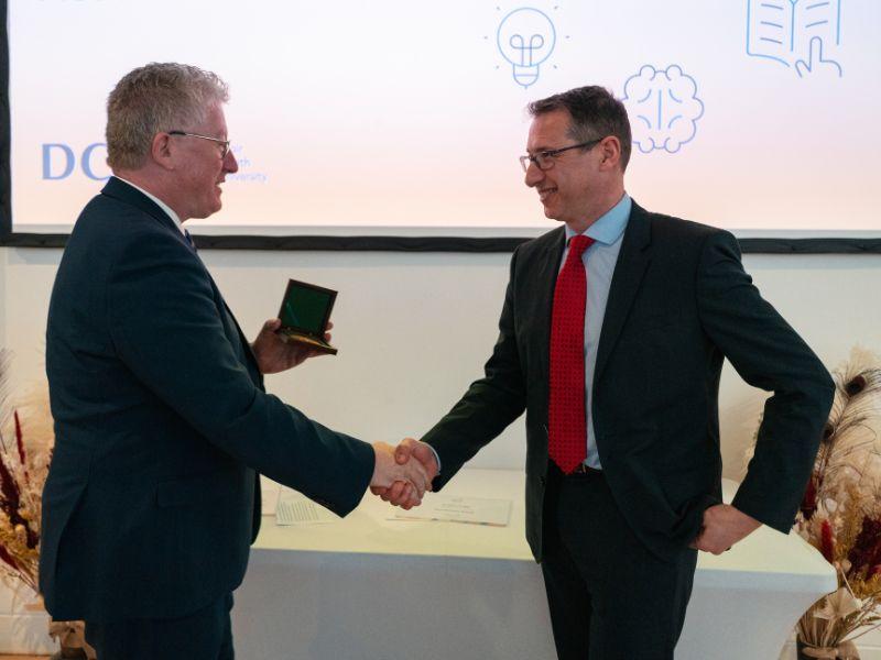 Shows professor nicholas dunne shaking hands with professor daire keogh
