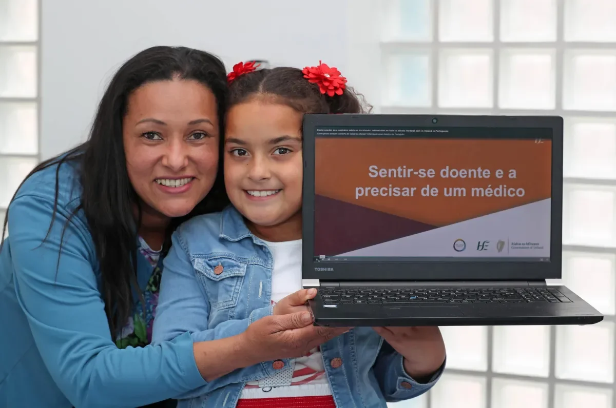 woman and child holding a laptop.