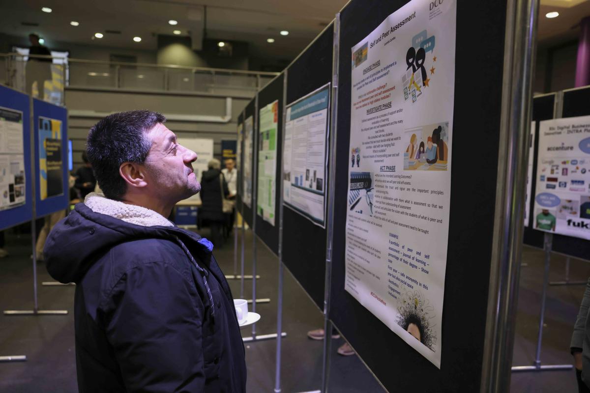 A man looks at a project at the DCU Futures Student Showcase