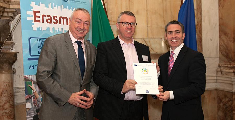 Damien English TD, Minister for Skills, Research and Innovation presenting Paul Smith the award for pioneering in the Erasmus+ I