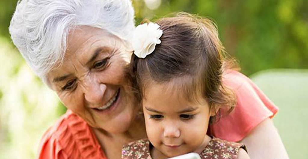 Older lady reading book to child