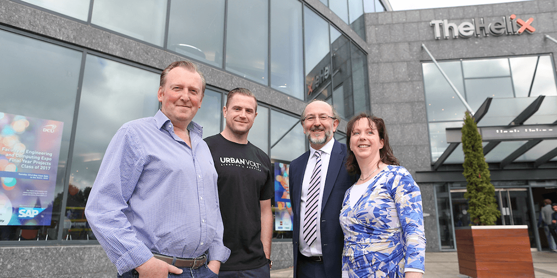 Representatives from DCU and UrbanVolt pose in front of the Helix