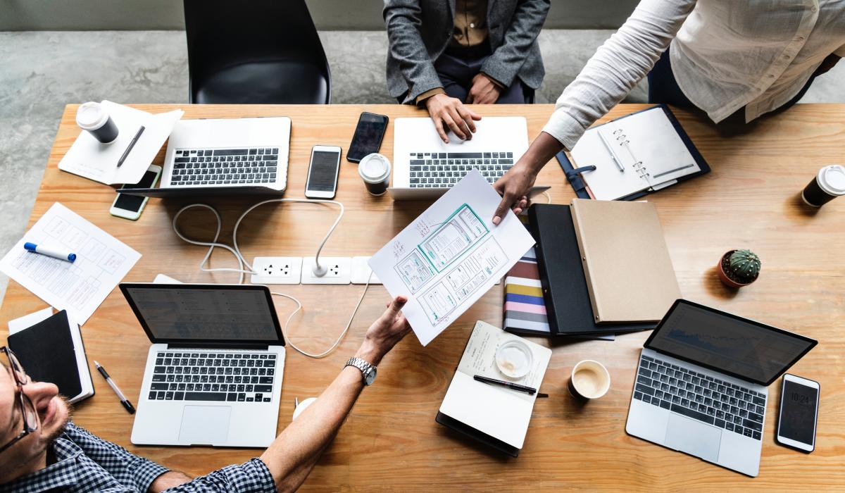 Group of people with computers sharing a schedule 