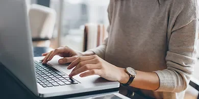 A student typing on a laptop.