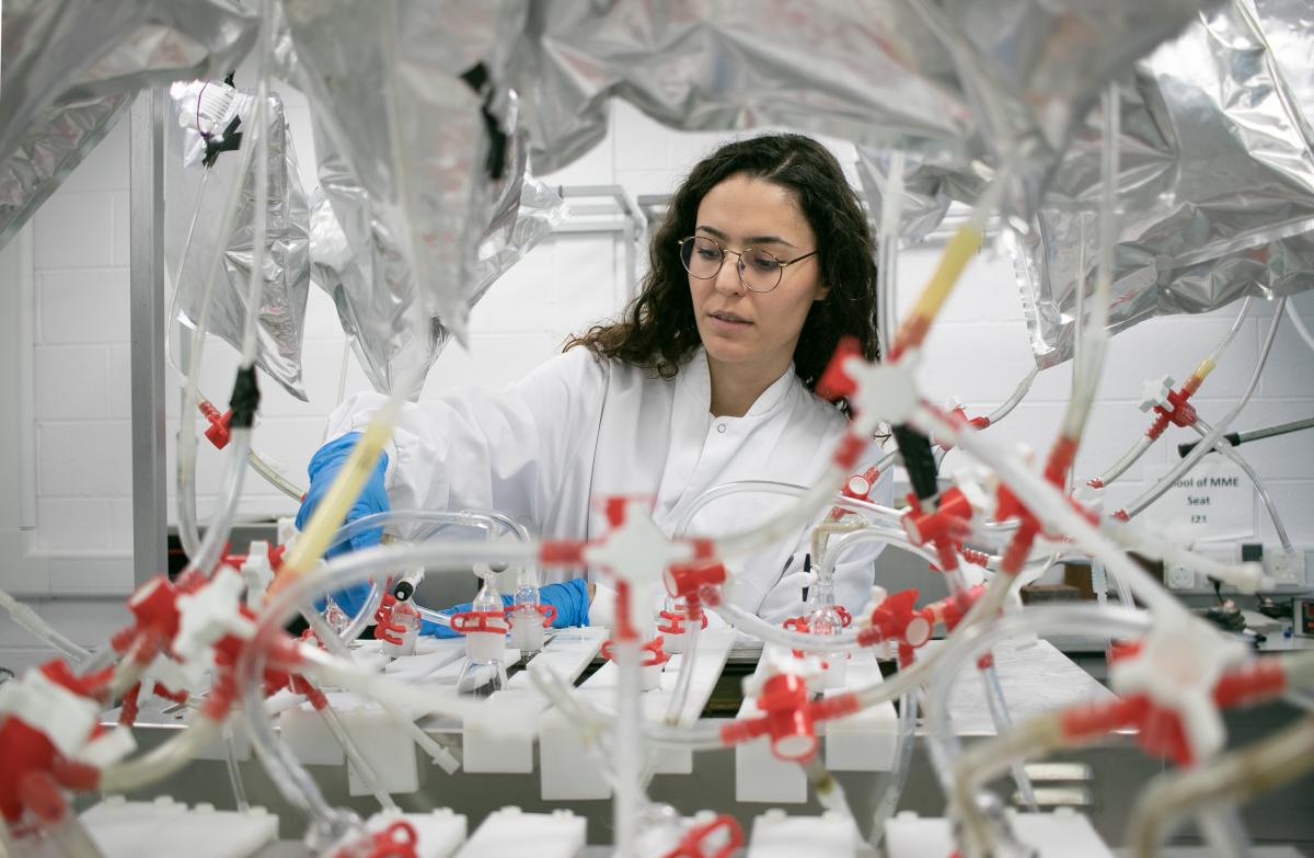 Assist. Prof. Burcu Gunes and the technical setup for harvesting renewable bioenergy