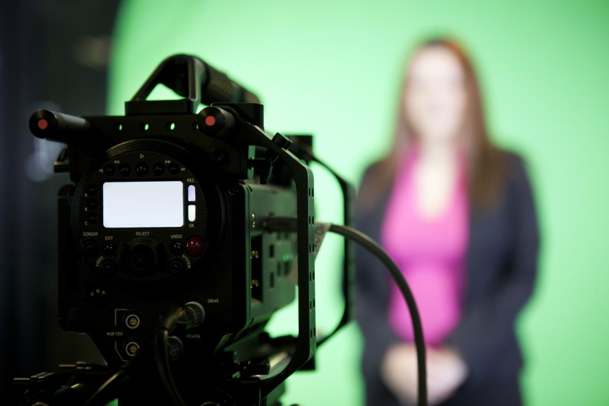 person using video camera in studio